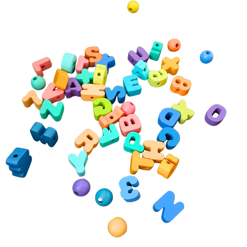 Scattered colourful alphabet beads and round beads for lacing and fine motor skill activities on a white background