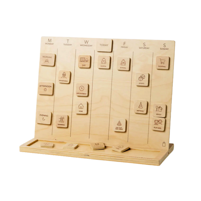Wooden visual schedule board with days of the week and movable tiles showing daily activities arranged on a stand on a white surface.